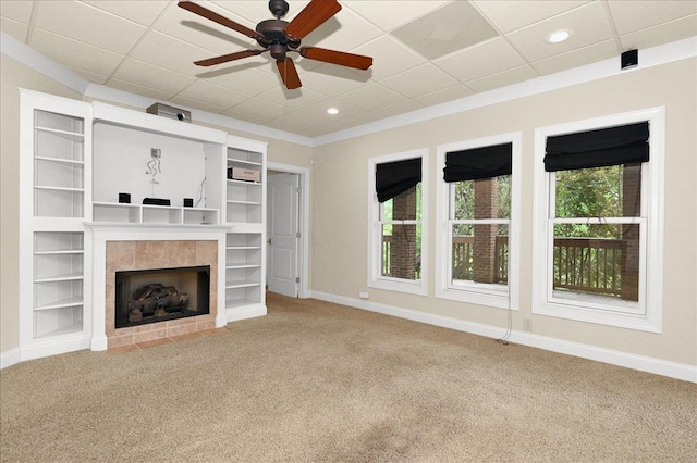 unfurnished living room featuring plenty of natural light, carpet, and a fireplace