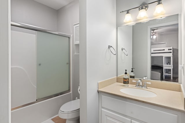 full bathroom with vanity, toilet, and enclosed tub / shower combo