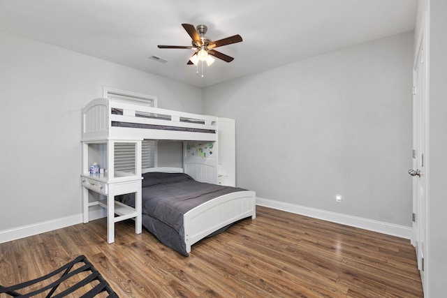 bedroom with ceiling fan and dark hardwood / wood-style flooring