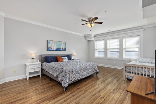 bedroom featuring ceiling fan, baseboards, ornamental molding, and wood finished floors
