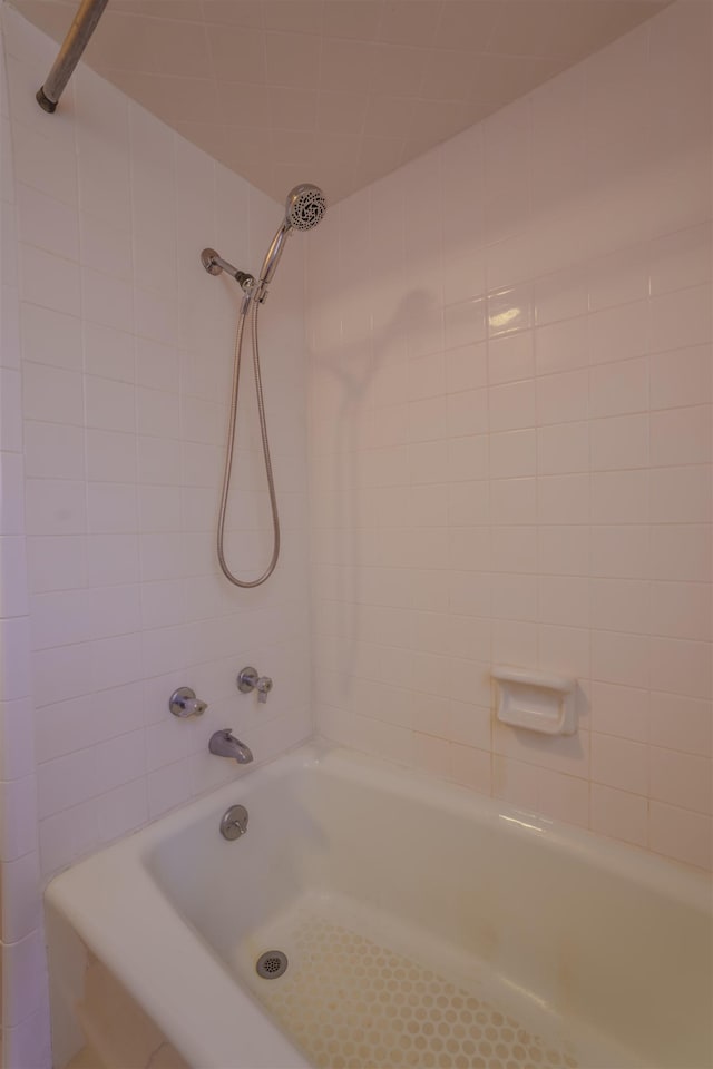  - bathroom featuring tub / shower combination