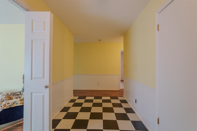  - hallway with wainscoting and tile patterned floors