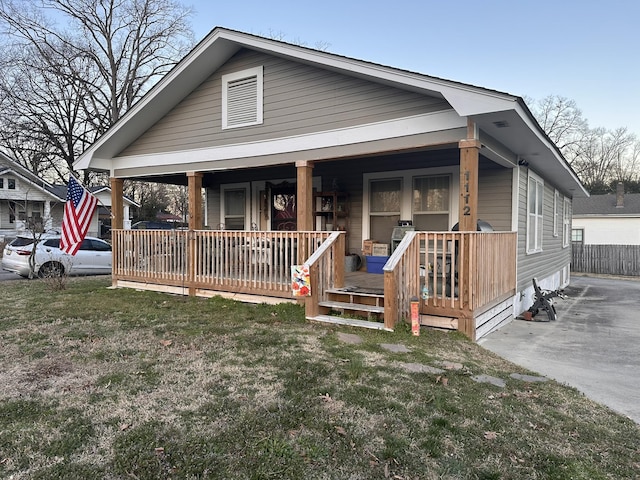 view of front of property with covered porch and a front lawn