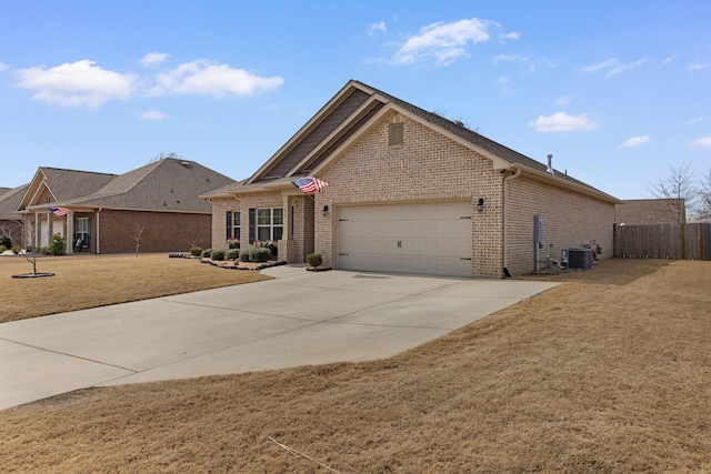 view of front of home with brick siding, central air condition unit, an attached garage, fence, and driveway