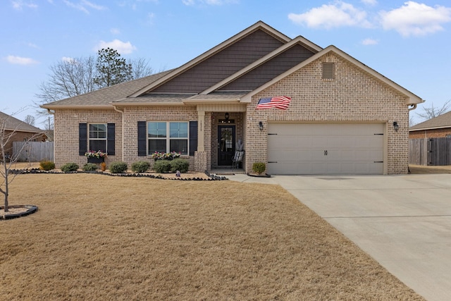 view of front of home with driveway, a garage, brick siding, fence, and a front yard