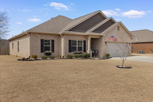 view of front of property with brick siding, roof with shingles, concrete driveway, an attached garage, and a front yard