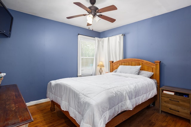  - bedroom with wood finished floors and a ceiling fan