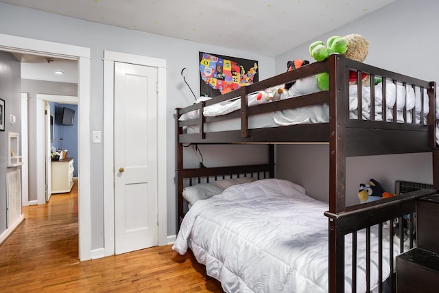  - bedroom with wood finished floors and baseboards
