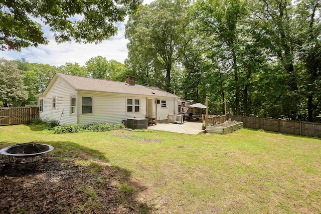  - back of property featuring an outdoor fire pit, a patio, a fenced backyard, and a chimney