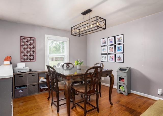  - dining area with light wood-style flooring and a chandelier