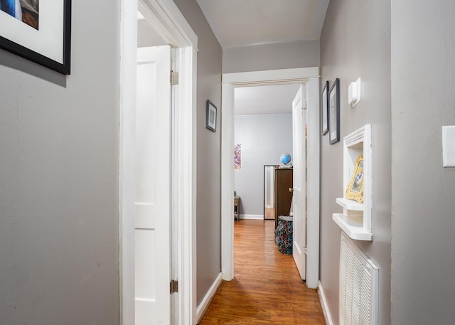  - hall featuring wood finished floors and baseboards