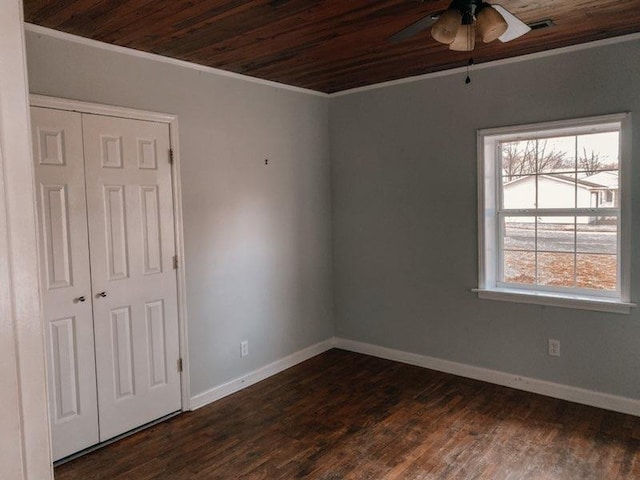 empty room with wooden ceiling, a ceiling fan, ornamental molding, and plenty of natural light