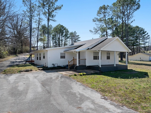 view of front of home with covered porch and a front yard