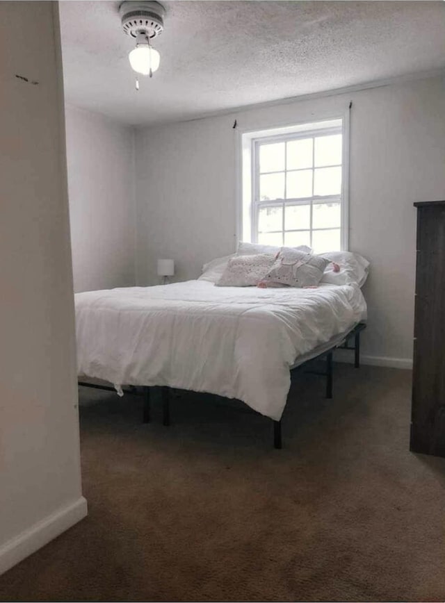 carpeted bedroom featuring baseboards