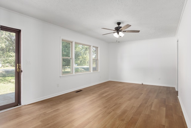 unfurnished room with ceiling fan, a textured ceiling, and light wood-type flooring