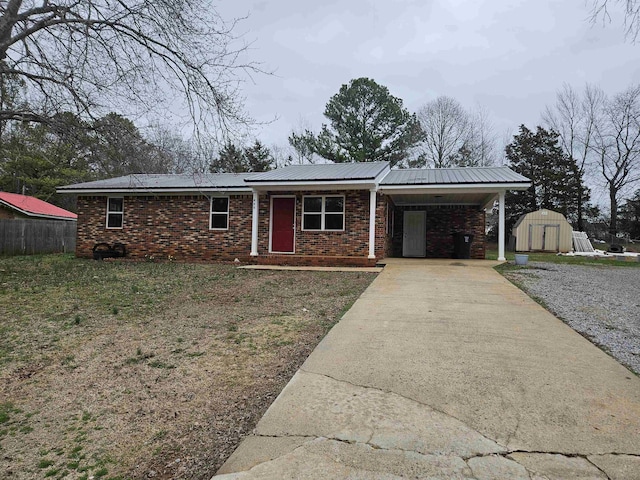 ranch-style house featuring a storage shed and a carport