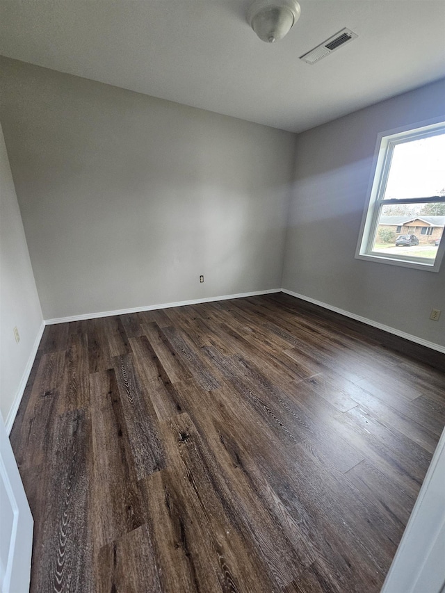 empty room with dark hardwood / wood-style floors