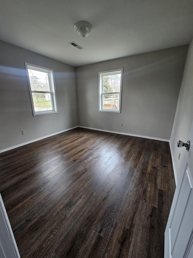 unfurnished room featuring dark hardwood / wood-style floors