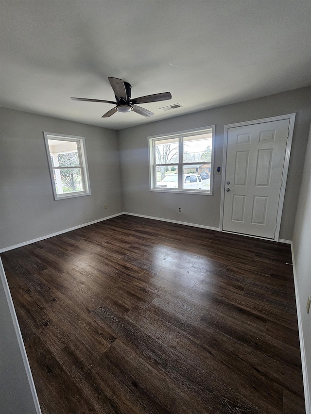 unfurnished room featuring ceiling fan and dark wood-type flooring