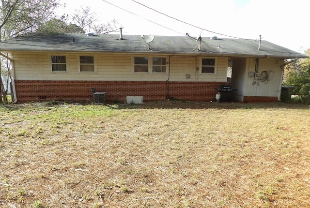 rear view of house with a yard and central air condition unit