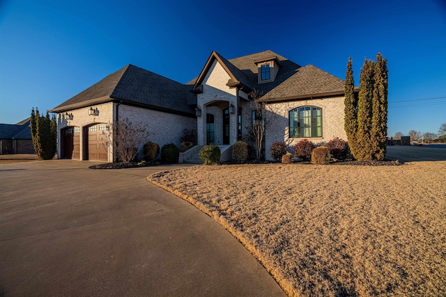 french country home featuring a garage