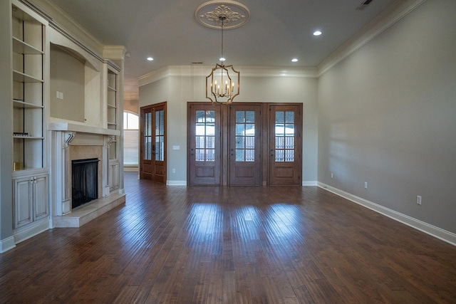 entrance foyer with an inviting chandelier, ornamental molding, and dark hardwood / wood-style floors