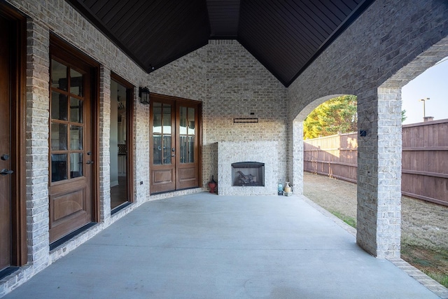 view of patio with french doors and a fireplace