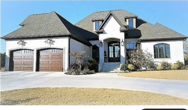 view of front of house with a garage and french doors