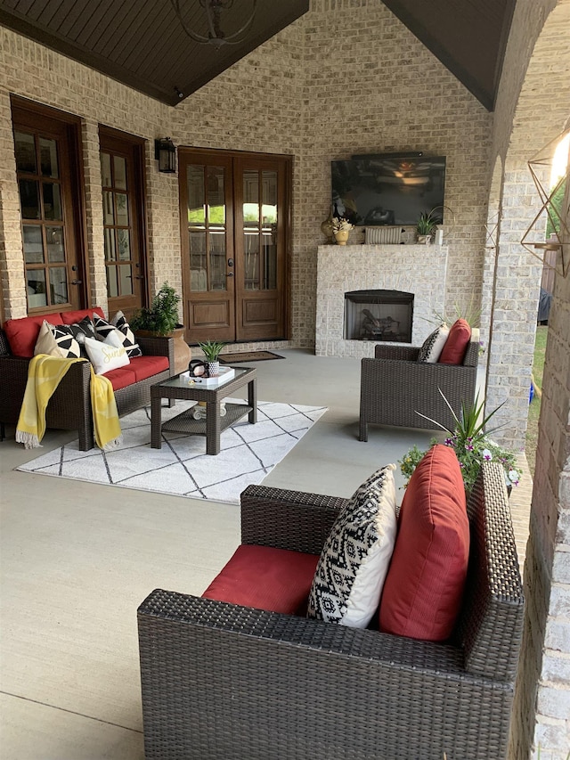 view of patio / terrace featuring french doors and an outdoor living space with a fireplace