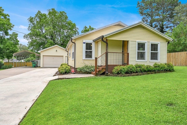  - view of front of property featuring an outbuilding, a detached carport, a detached garage, and covered porch