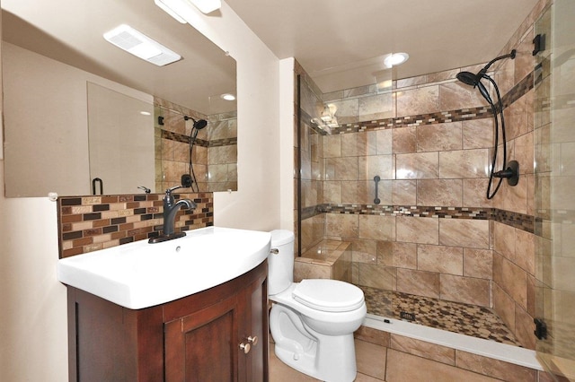  - full bathroom featuring a tile shower, vanity, and tasteful backsplash