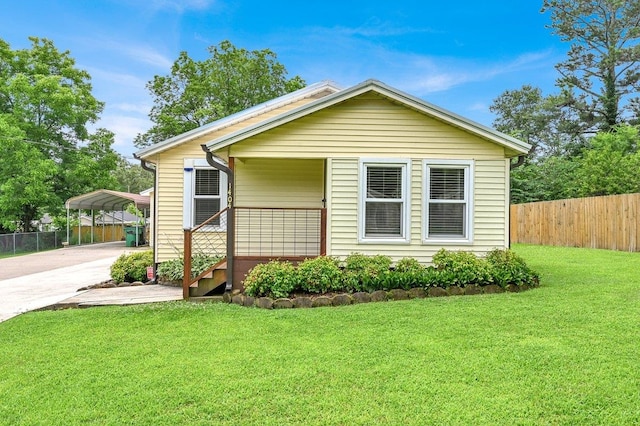  - view of front of property featuring a detached carport, driveway, and covered porch