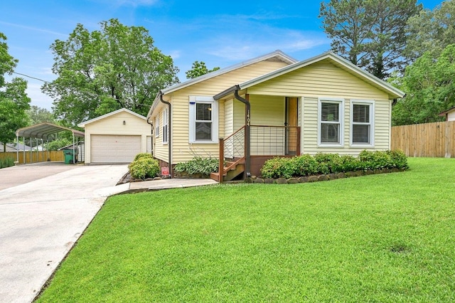  - view of front of house featuring an outbuilding, a carport, concrete driveway, and a detached garage