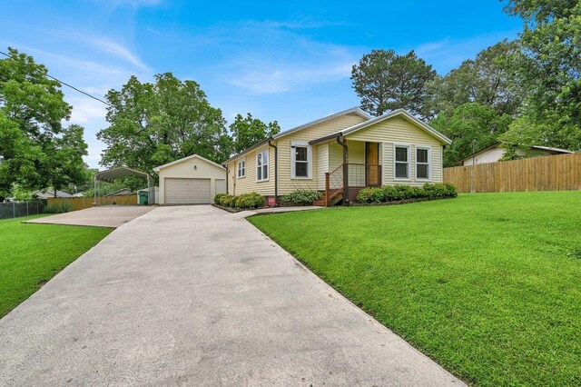  - ranch-style house featuring an outdoor structure, a detached garage, and a carport