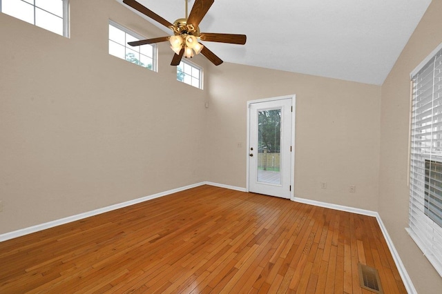  - empty room featuring ceiling fan, light wood-style flooring, and high vaulted ceiling