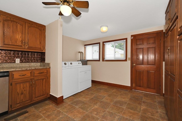  - laundry area featuring washer and dryer, ceiling fan, and stone finish flooring