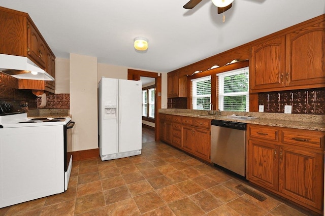  - kitchen with white appliances, premium range hood, tasteful backsplash, brown cabinets, and ceiling fan