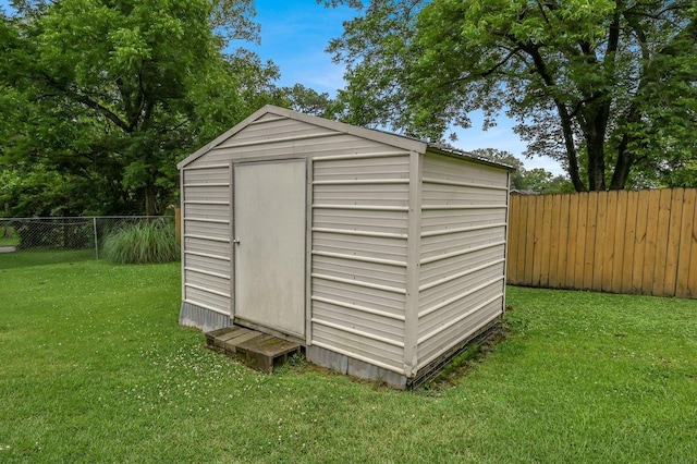  - view of shed featuring a fenced backyard