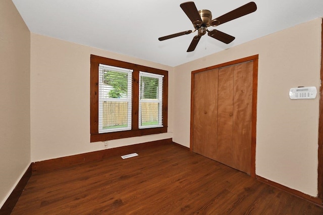  - unfurnished bedroom with wood finished floors, a closet, and a ceiling fan