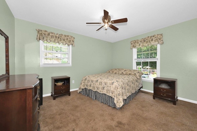  - carpeted bedroom featuring multiple windows and a ceiling fan