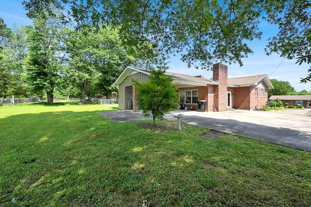  - ranch-style home featuring a chimney, brick siding, and board and batten siding