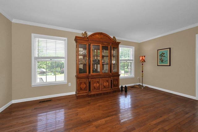  - empty room featuring crown molding and dark wood-type flooring