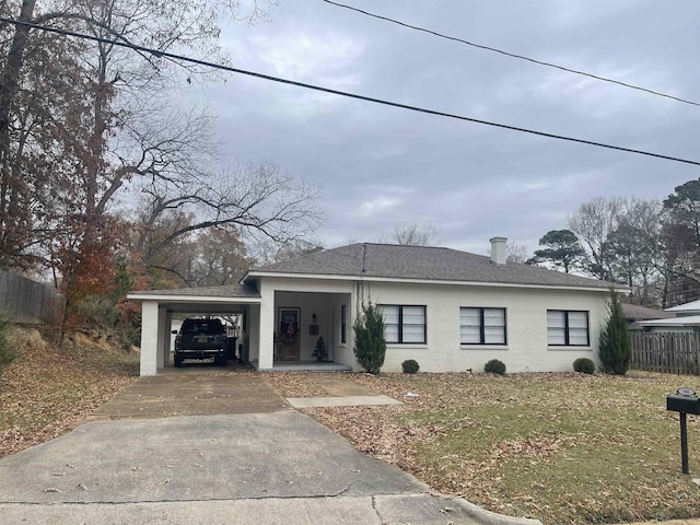 view of front facade with a front yard and a carport