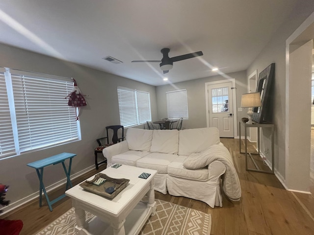 living room with hardwood / wood-style flooring and ceiling fan