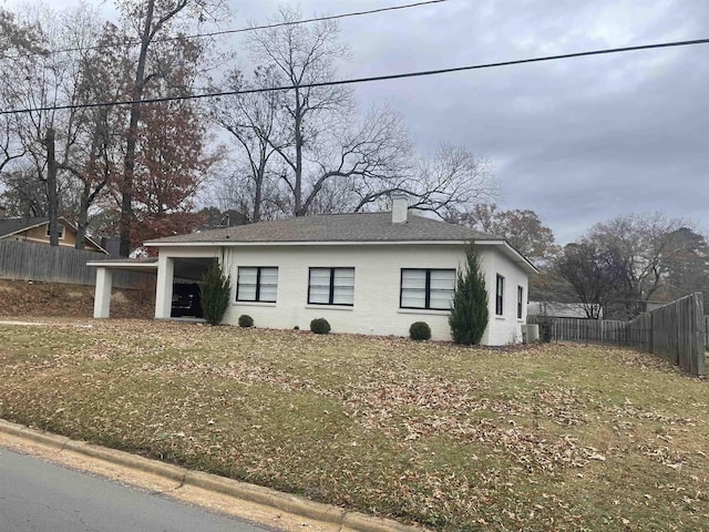 view of front of house with a front yard and central AC