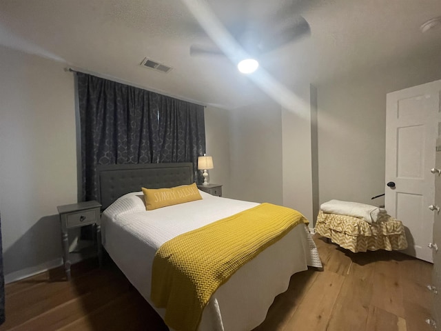 bedroom with hardwood / wood-style flooring and ceiling fan