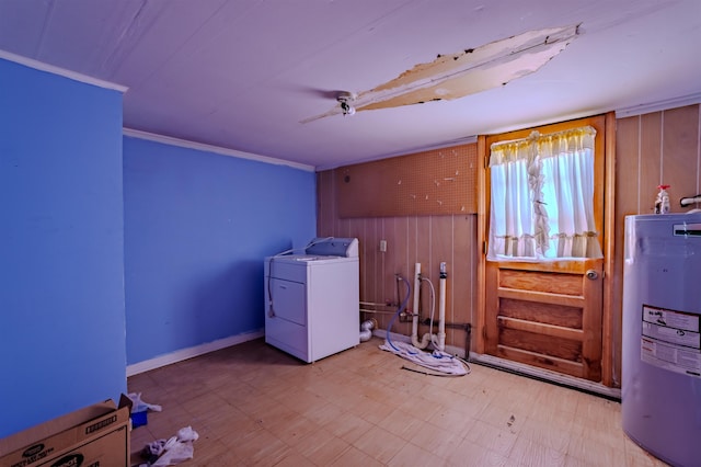 clothes washing area featuring tile patterned floors, electric water heater, laundry area, and washer / dryer