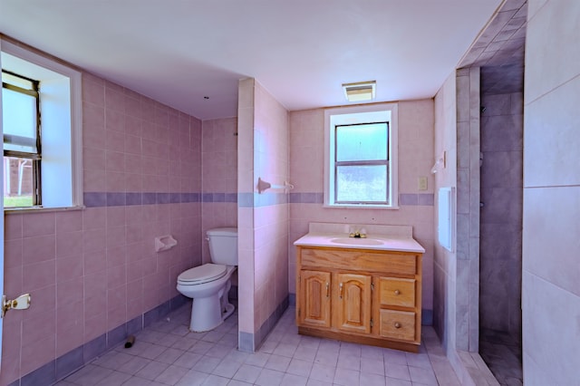 bathroom with tile walls, toilet, and tile patterned floors