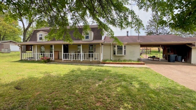 view of front of property with covered porch, an attached carport, a front yard, and concrete driveway