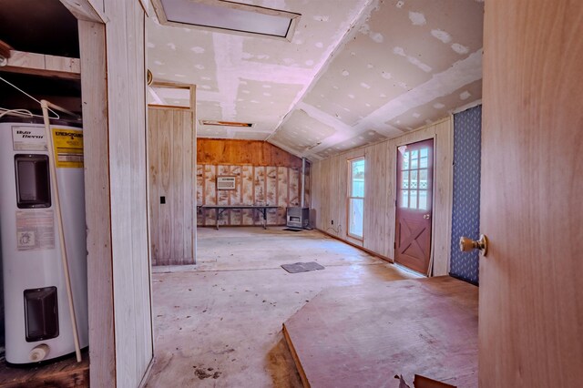 bonus room with vaulted ceiling and electric water heater